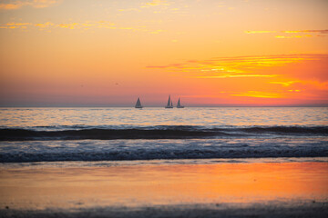 Sunset in the sea with beautiful clouds. Sunrise ocean seascape.