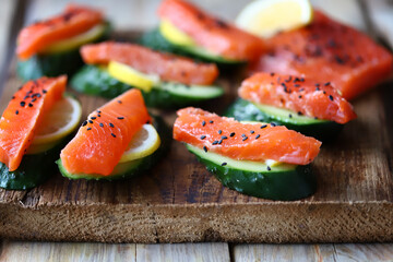 Selective focus. Sushi on a cucumber. Salmon with cucumber and spices.