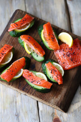 Selective focus. Sushi on a cucumber. Salmon with cucumber and spices.