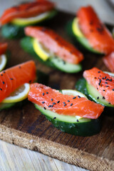 Selective focus. Sushi on a cucumber. Salmon with cucumber and spices.