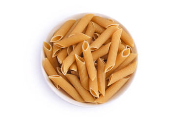 Wolegrain penne pasta from durum wheat in bowl isolated on white background with clipping path and full depth of field. Top view. Flat lay,