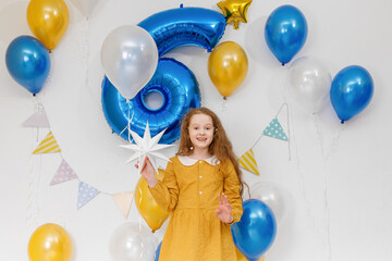 Fototapeta na wymiar Happy birthday girl with confetti and balloons. Home holiday concept in quarantine.