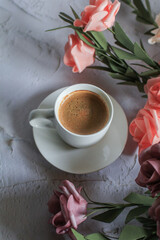 Coffee cup with rose flower on white table background. Valentine day with place for text. Vintage photo. Space for text