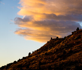 Sunrise hillside with clouds in background