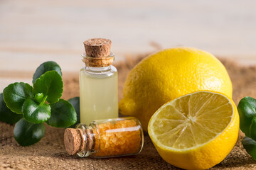 Health care concept. Organic cosmetics with lemon. Product for spa and aromatherapy. Natural moisturizer on wooden background.