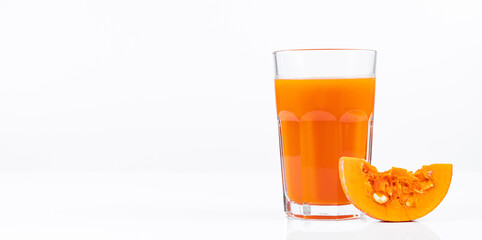 Pumpkin juice in transparent glass isolated on white background. Vegetable vegetarian drink. Healthy food and diet.