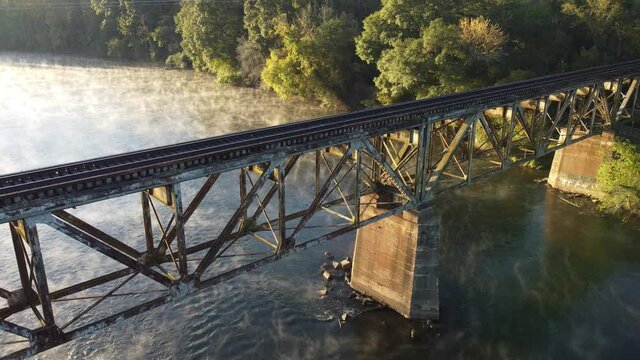Aerial view of old railroad trestle with mist rising from Catawba River in South Carolina, USA
