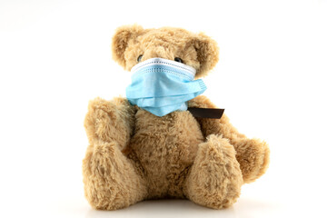 Teddy bears wearing protective mask, Teddy bear are sitting in blue medical masks on white background, Concept of protection from respiratory disease,Stop Coronavirus and Air pollution concept