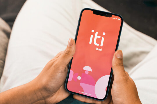 Female hand holding a smartphone with Iti Ita&uacute; bank App on the screen . Rio de Janeiro, RJ, Brazil. October 2021