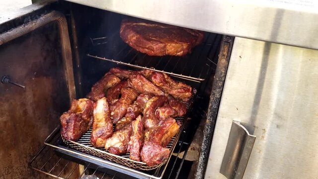 Home cooking - Pulling pork riblets and beef chuck to check how the meat being smoked in small gas smoker.