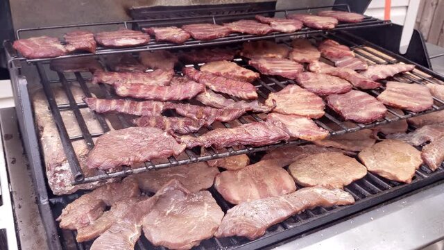 Home cooking - Lot of beef jerky being smoked and slowly dehydrated in custom modified gas grill.