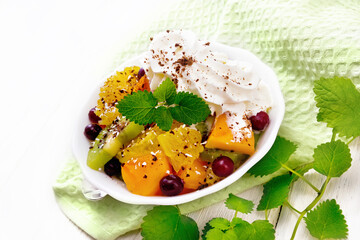 Salad fruit with cranberries in bowl on napkin