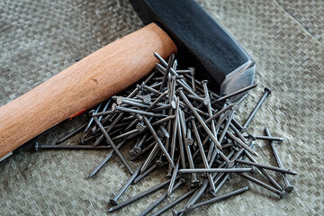 hand tools, old tools. hammer and nails on a construction surface, close-up