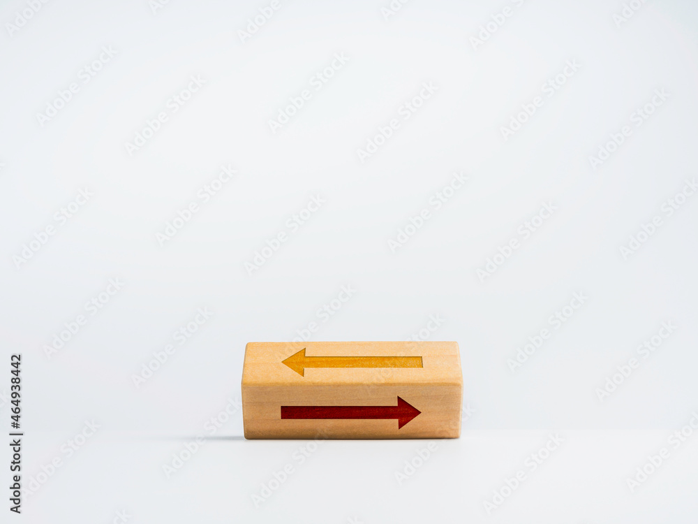 Poster flipping wooden block with two different arrows icon moving opposite way on white background. choosi