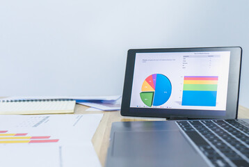 business data graph on tablet with left white copy space background