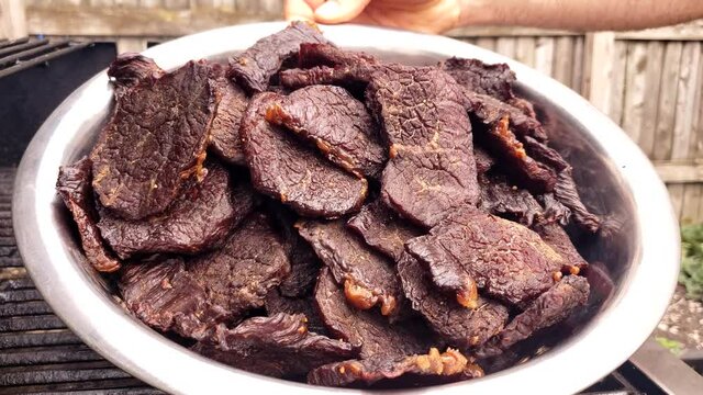 Home cooking - Bowl full of beef jerky right after meat been smoked and dehydrated and cooled down.