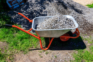 Wheelbarrow with gravel at the construction site