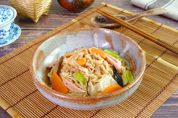 Vegetarian Hong Kong Noodle.  Stir fried Hong Kong noodle with mushroom, carrots, green vegetables and veggie sausage. Chinese vegetarian noodle for vegetarian festival.