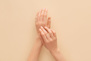 Female hands on light background