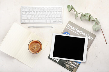 Composition with cup of coffee, tablet computer, notebook and keyboard on light background