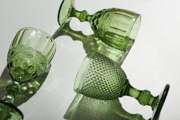 Beautiful empty glasses on grey background, closeup