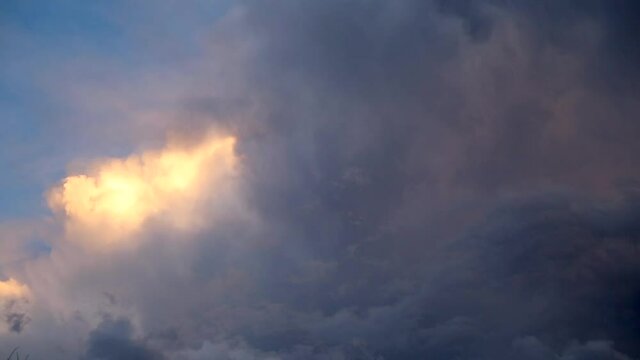 heavenly clouds with a spot of sun shinning on them as a storm rolls in.   