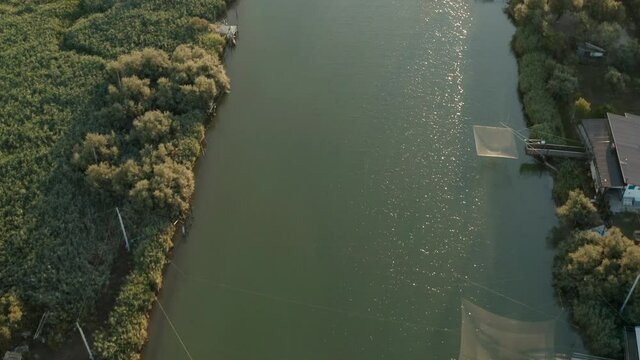 Aerial view of the fishing huts in the river that flows into the Adriatic sea, Lido di Dante, Fiumi Uniti, Ravenna near Comacchio valley.