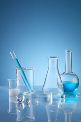 Front view of scientist working with chemical reaction in chemistry laboratory. . Blue liquid in...