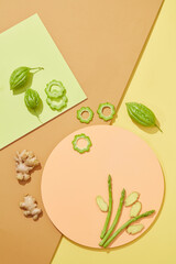 Top view of cosmetics with bitter melon and Ginger , asparagus extract in colorful background for...