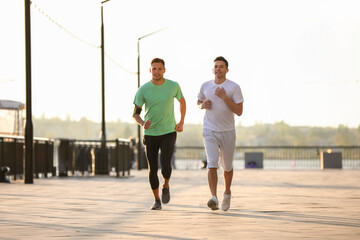 Fototapeta premium Sporty young men running outdoors