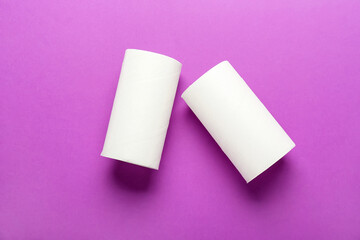 Empty toilet paper tubes on purple background
