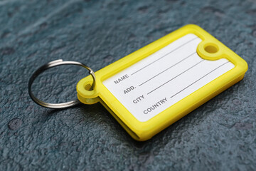 Plastic key tag on dark background