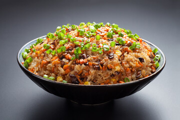 Cantonese fried glutinous rice with mushroom, corn, carrots and sausage. Chinese Food.