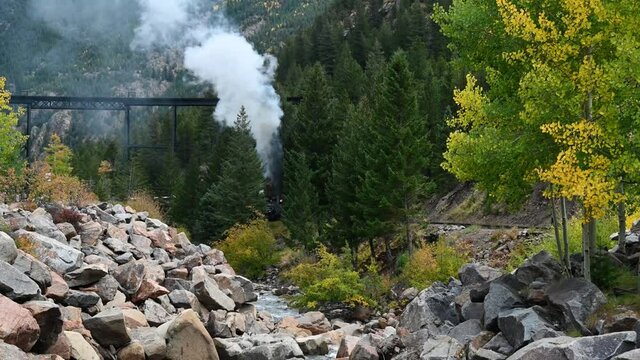 Steam locomotive carrying passengers through a mountain pass in Colorado, Static