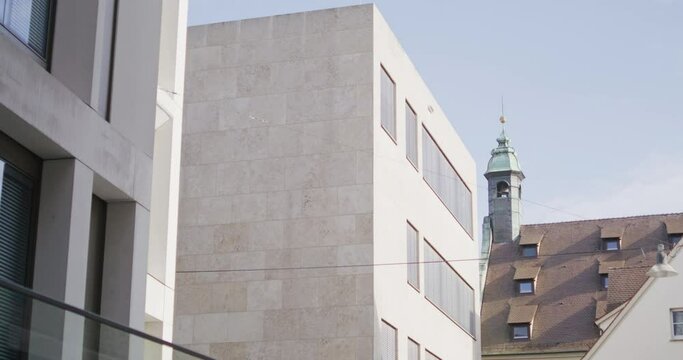 Medium wide shot of the backside of the synagogue of Ulm. Camera tracking to the right. Sunny day with blue sky und a few white clouds.