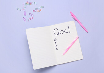 Notebook with empty to do list and stationery on grey background. New year goals