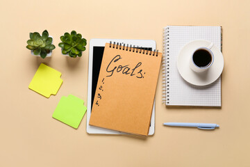 Notebook with empty to do list and tablet computer with stationery on color background. New year...