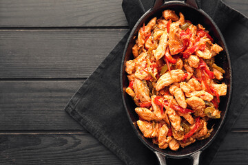 Frying pan with tasty Fajita on dark wooden background