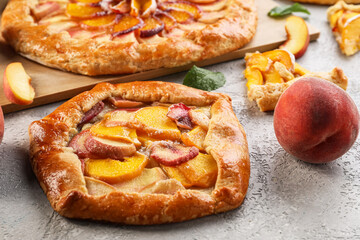 Tasty peach galette on light background, closeup