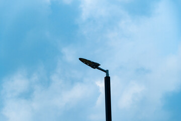 silhouette street light, Lamp Post with white cloud and blue sky background