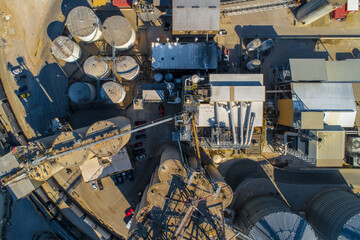 Overhead Aerial Shot of a Grain Transfer Facility. Silos, Grain bins, Conveyors, Trains, Trucks, etc. 