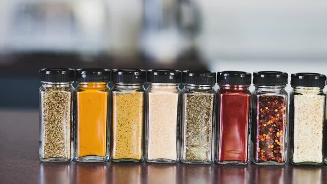 spices seeds and seasonings in mathing spice jars on kitchen benchtop, simple vegan ingredients and flavoring your dishes