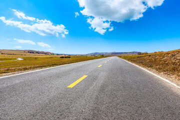 Empty asphalt road and mountain nature landscape under blue sky.