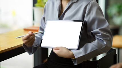 Businesswoman shows and explains the information on tablet screen