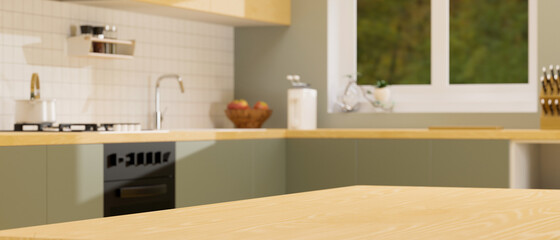 Wooden kitchen counter island for montage over blurred vintage green kitchen interior background.