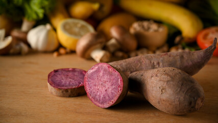 Slice of purple sweet potatoes, yams on wooden surface