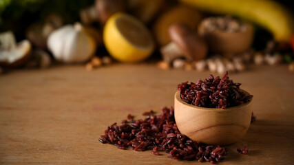 Cooked rice berry in a wooden bowl on wooden background - Powered by Adobe