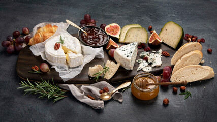 Cheese assortment on dark background.