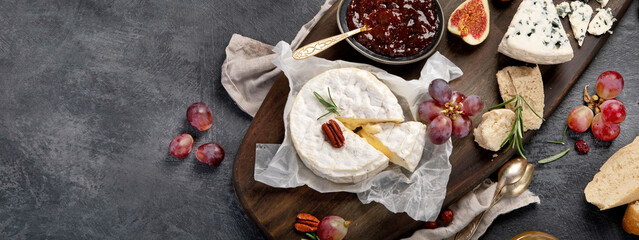 Cheese assortment on dark background.