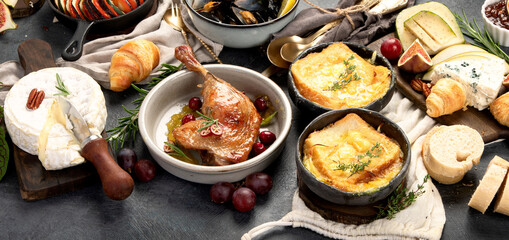 French food assortment on dark background.
